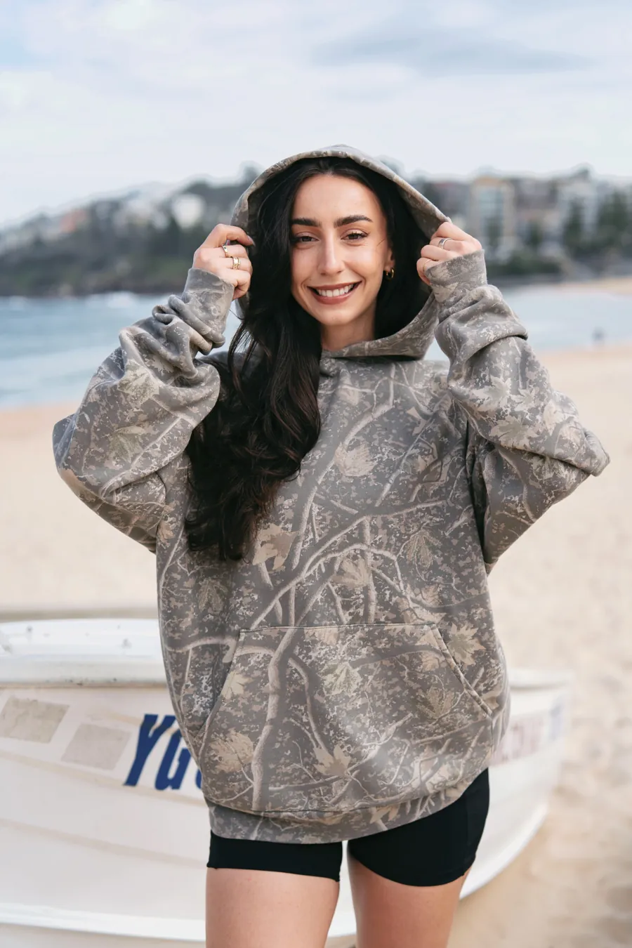 Woman in a Deadwood Camo Heavyweight hoodie at the beach
